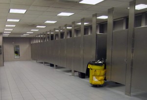 a bathroom with a yellow trash can