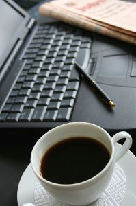 a cup of coffee next to a keyboard