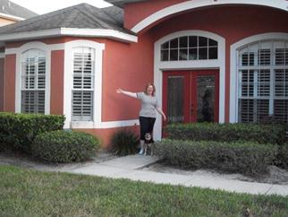a woman standing in front of a house