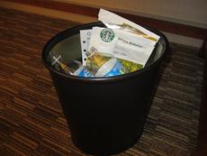 a black trash can with various trash bags
