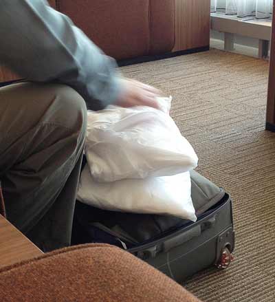 a person packing a suitcase