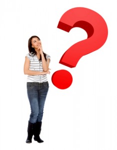 a woman standing next to a question mark