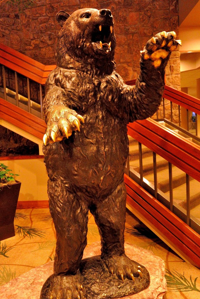 a statue of a bear with a hand up