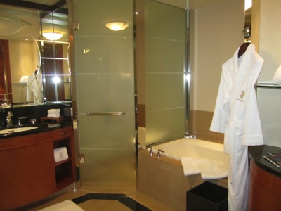 a bathroom with a bathtub and bathrobe